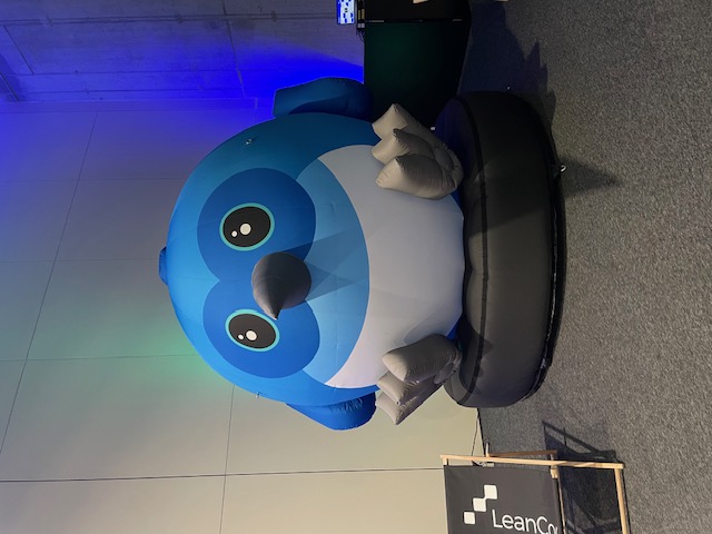 A blow up figure of Dash - the Flutter mascot.